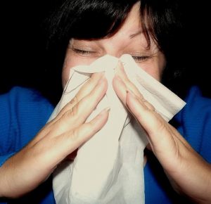 Woman sneezing with Hanky