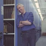 Photo of Dr Simon Raybould in library stacks